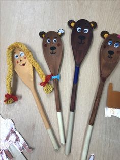 five wooden spoons with animal faces on them