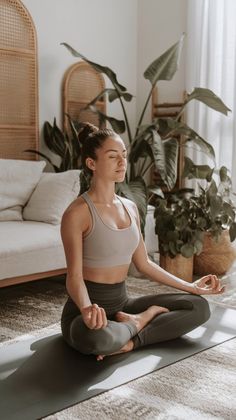 a woman is sitting on the floor in a yoga pose