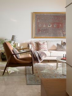 a living room filled with furniture and a painting on the wall