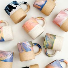 coffee mugs painted with different colors and designs