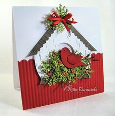 a christmas card with a red bird and wreath hanging from it's side on a white background