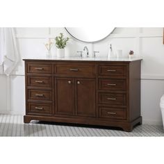 a white toilet sitting next to a wooden sink vanity in a bathroom under a mirror