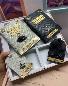 three different types of purses are in a box, one is gold and the other is black