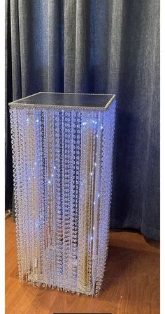 a table that has some lights on it and is in front of a blue curtain