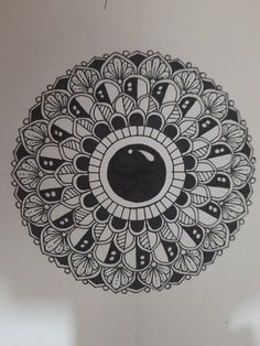 a black and white drawing of a circular object in the middle of a circle with an eyeball on it