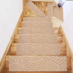 the stairs are made of wood and have decorative designs on them, along with a vase