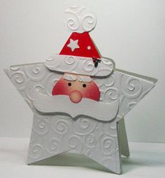 an ornament in the shape of a star with a santa hat