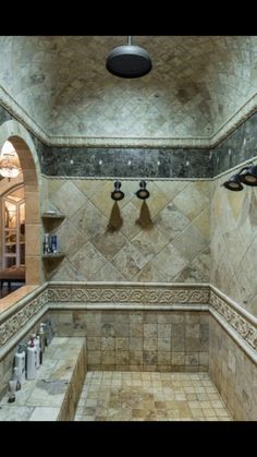 a bathroom with tiled walls and flooring next to a sink in the middle of it