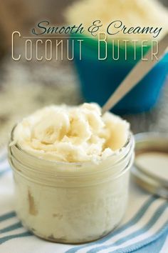 a small jar filled with coconut butter on top of a blue and white towel next to a spoon