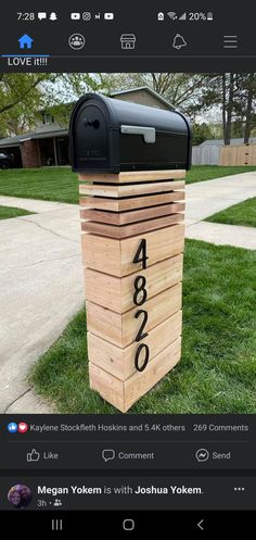 a mailbox sitting in the grass with numbers on it's front and side