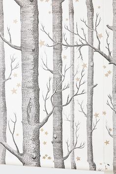 a wallpaper with trees and stars on the back in white, gold and grey