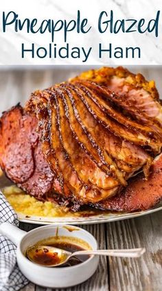 pineapple glazed holiday ham on a platter with mashed potatoes and gravy