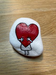 a painted rock with a heart on it