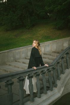 a woman standing on top of a set of stairs