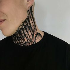 a man with his neck tattoo covered in black ink