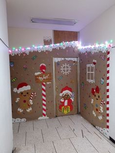 an open door decorated with gingerbreads and candy canes in a room that has christmas decorations on the walls