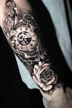 a man's arm with a clock and roses on it