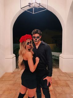 a man and woman dressed up in skeleton makeup