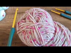 a ball of yarn sitting on top of a table next to crochet hooks