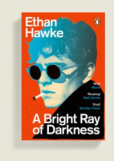 the cover of a bright ray of darkness by nathan hawke, with sunglasses on his face