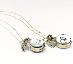 "A mini round shape locket will keep the ones you love close to your heart. Made from a glass and yellow brass round shape that hangs on sterling silver cable chain or 14k Gold Filled Cable chain. This locket is glass on both sides and holds TWO photos that will be sized down to fit. The hand stamped silver word tag can be made to say whatever you want to personalize your photo locket! One short word as shown will fit on tag. Hangs best longer at about 28 inches and can include a different photo Unique Locket Necklace, Unique Locket, Constellation Ring, Waterfall Necklace, Memory Locket, Glass Locket, Butterfly Bracelet, San Clemente, Photo Locket