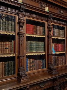 an old wooden bookcase with many books on it's sides and shelves full of books