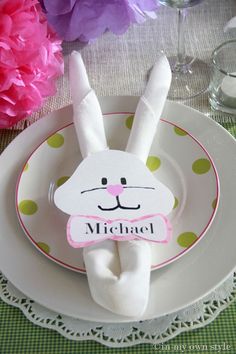 a white plate topped with a bunny rabbit napkin holder