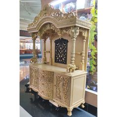 an elaborately carved wooden cabinet in a store