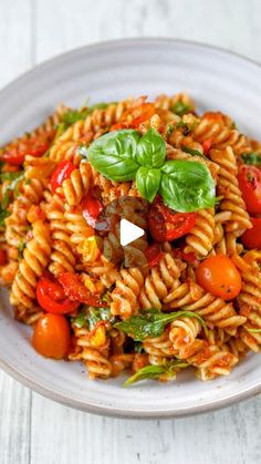 a white bowl filled with pasta and vegetables