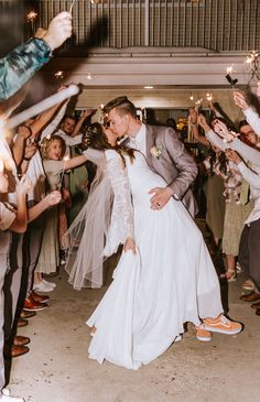 a bride and groom are dancing with sparklers