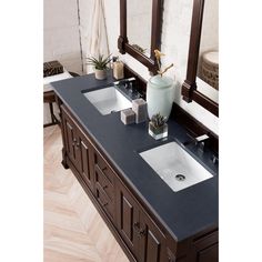 a double sink vanity with two mirrors above it