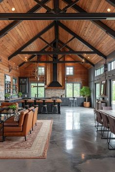 a large open living room with wood paneling and high ceilings is featured in this image