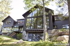 a large house sitting on top of a lush green hillside