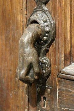 an old door handle on a wooden door