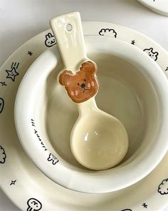 there is a spoon with a teddy bear on it