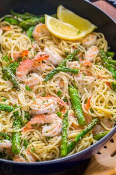 pasta with shrimp, asparagus and lemon in a skillet on the table