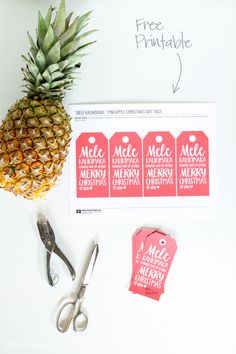 pineapple next to scissors and other items on a white surface with free printable tags