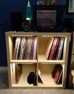 an entertainment center with cd's and movies on it