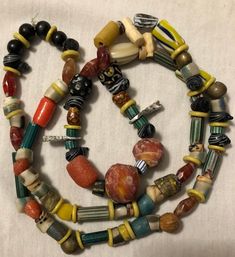 This is a fabulous 30 inch strand of assorted beads and amulets just filled with VERY collectible and somewhat rare antique beads. The tribal inspired 20-30 year old assemblage boasts a really great collection and is ready to wear or re-purpose. Beads are in good pre-owned condition with expected wear. The necklace has been strung for a while and will eventually need to be restrung. I do NOT guarantee any stringing, so bear that in mind. Antique and vintage necklaces like this are often on old s Antique Beaded Necklaces For Jewelry Making, Antique Gemstone Beads For Jewelry Making, Antique Style Colorful Beads For Gift, Antique Multicolor Beaded Necklaces With Round Beads, Antique Jewelry With Colorful Oval Beads, Antique Round Beads For Jewelry Making, Antique Amber Beaded Necklaces With Large Beads, Antique Multicolor Round Bead Necklaces, Antique Multicolor Jewelry With Polished Beads