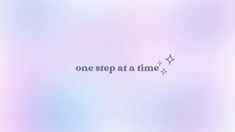 the words one step at a time are written on a blurry blue and pink background