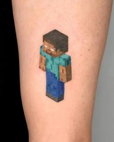 a small pixel art tattoo on the leg