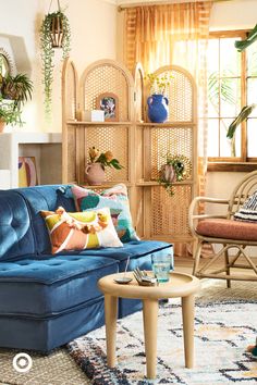 a living room filled with furniture and plants