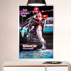 a movie poster is hanging on the wall next to a record player's cabinet