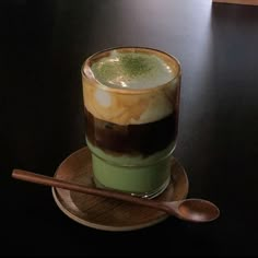 a cup filled with liquid sitting on top of a wooden plate