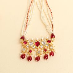 This unique Tanmani features 5 white-colored stones, complemented by pearls woven into the necklace strings. Red drop shape beads add a charming touch, enhancing the beauty of this exquisite design. Inspired by the Peshwa style, this necklace is a popular choice among women in Maharashtra. Crafted with 3mm pearls strings intricately woven and decorated with Jeri, the necklace comes with an adjustable thread. Please note that this is our handmade creation. You may also consider pairing it with our best-selling pearl earrings (kudi). This ethnic necklace is made by my DAD.  Length - 17 inches with adjustable thread. Pearl Studs that goes well with this design: https://zivarcreations.etsy.com/listing/661244418 Temple Style Pearl Beaded Necklace For Gifts, Temple Jewelry Pearl Beaded Necklace For Gifts, Pearl Beaded Necklaces For Gifts In Temple Jewelry Style, Pearl Beaded Temple Jewelry Necklace For Gifts, Festival Pearl Drop Necklaces With Round Beads, Traditional White Kundan Pendant Necklace, Traditional Adjustable White Kundan Necklace, White Necklace For Festivals Gift, White Necklace For Festivals And Gifts