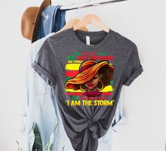 I Am The Storm Strong African Woman, They Whispered to Her You Cannot Withstand The Storm She Whispered Back I am the Storm Shirt, African Shirt, Inspirational Shirt, Feminism Tee, Women Empowerment Shirt, I am the Storm,  GUIDANCE *All our simple color t-shirts are 100% Cotton. *All our Heather Color t-shirts are 90% cotton 10% polyester blend and they are extremely soft. Our design are made very professionally with the right equipment *Soft and High-Quality Fabric *Taped shoulder-to-shoulder *Tear away label *Retail fit *Pre-shrunk * Side Seamed *Design size and placement is approximate. Each shirt is custom hand made exact size and placement of design may vary. FONTS AND DESIGN *Due to monitor differences, actual colors may vary slightly from what appears online. *You can choose your te African Shirt, She Whispered, I Am The Storm, African Shirts, Inspirational Shirt, African Women, Tshirt Colors, Women Empowerment, Colorful Shirts