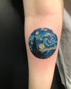 a person with a tattoo on their arm that has a starry night sky in the background