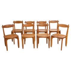 six wooden chairs are lined up in a row