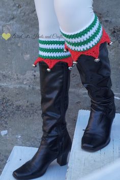 a pair of black boots with red and green striped socks on top of each boot