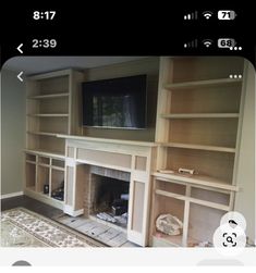 an empty living room with built in bookshelves and fireplace